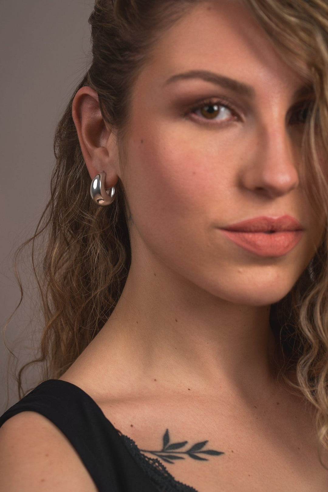 Elise hoop worn by model — sculptural softness in silver tone