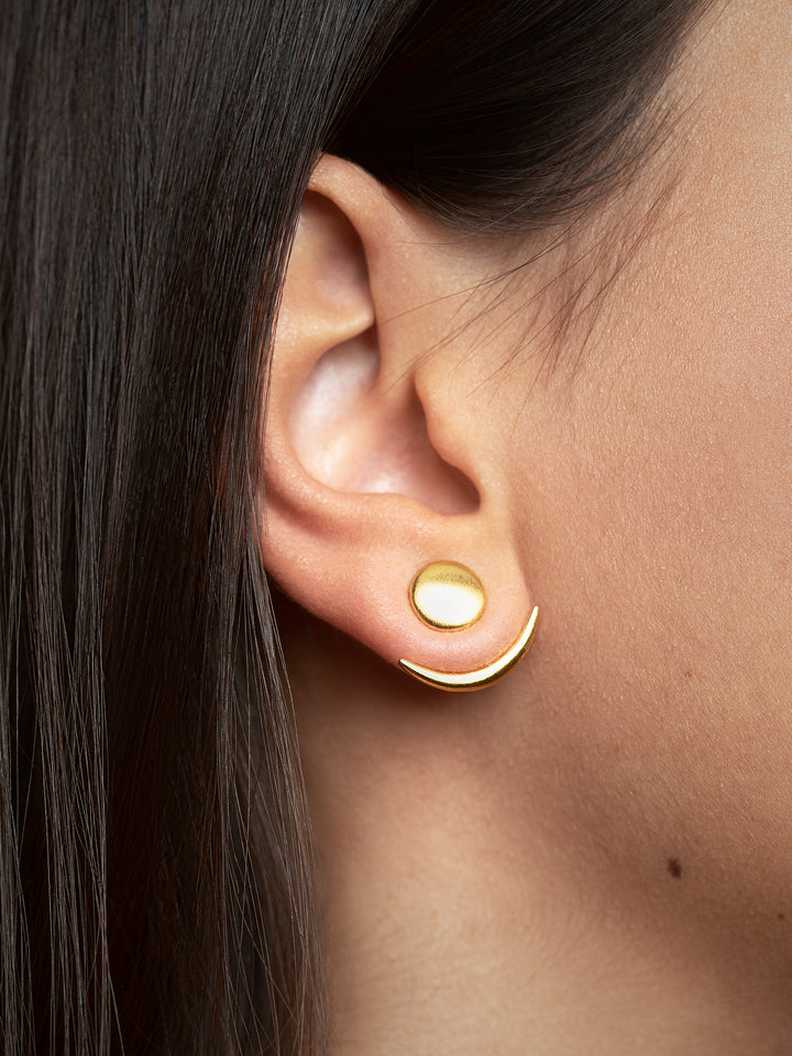 Gold matte ear jackets worn on the lobe, side view on a model with tan skin.