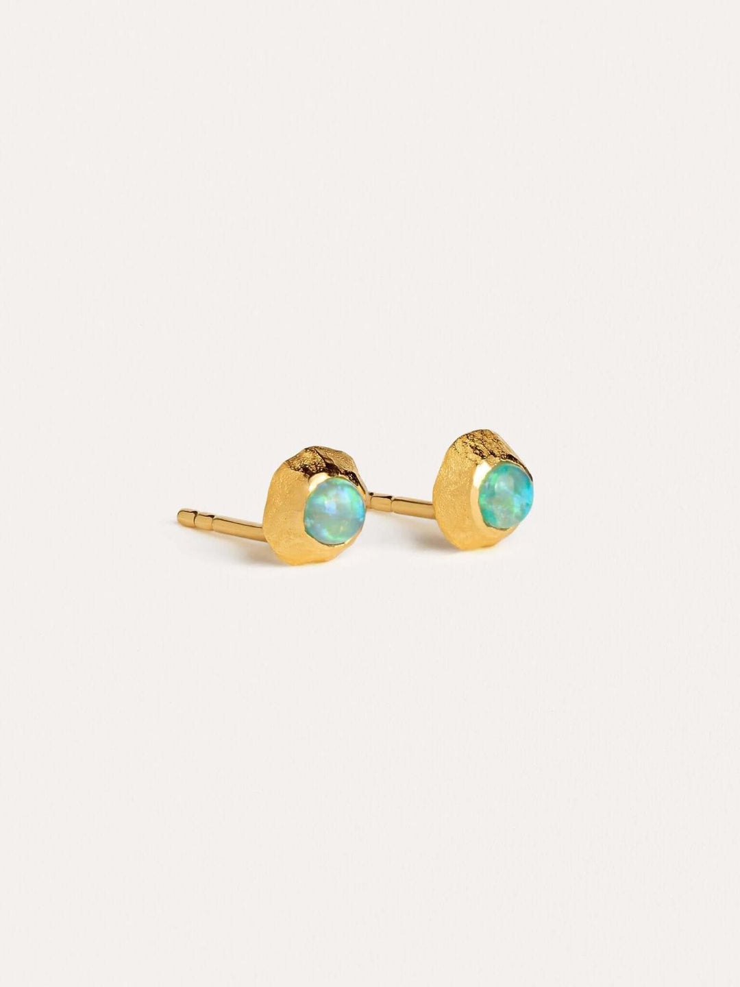 Small gold stud earrings with round-cut green gemstones