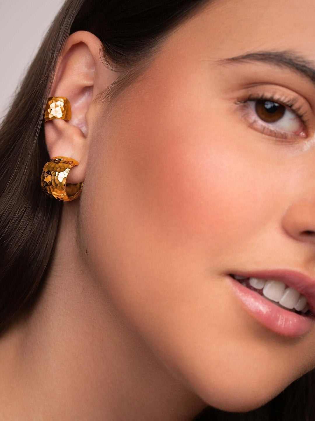 Model wearing the gold hammered conch cuff, styled on the upper ear for a refined look.