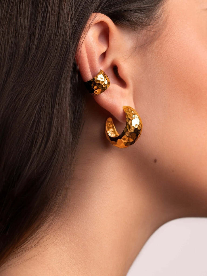 Model wearing the gold conch cuff earring, adding a subtle statement to her everyday style.