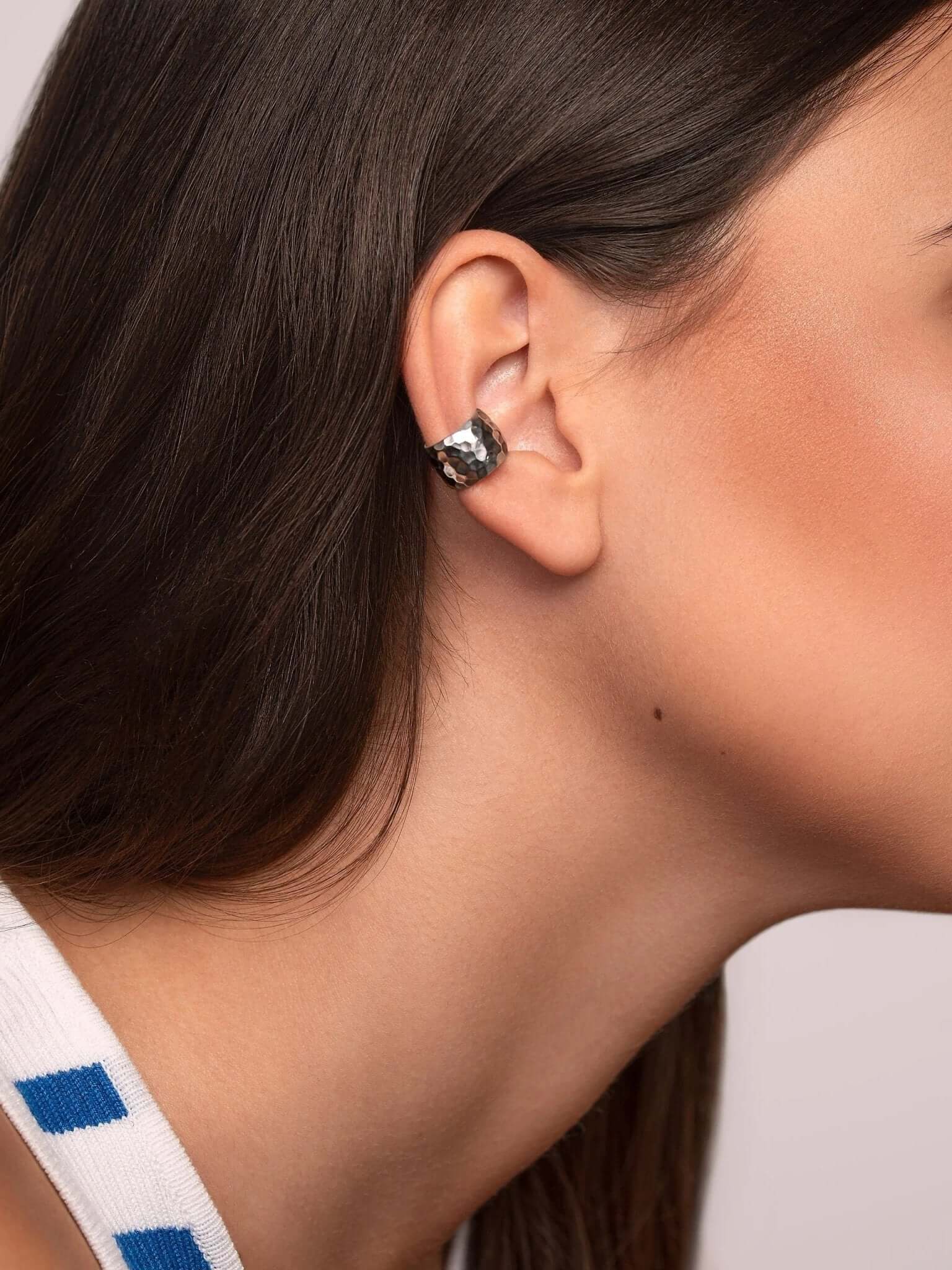 Side profile of the eco-friendly gold conch cuff earring, highlighting its natural shine and shape