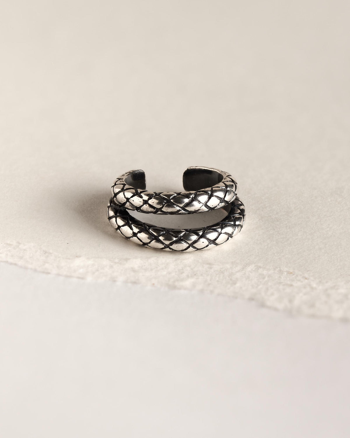 Front view of the oxidized silver double row snake ear cuff, showing the sculpted scales and dark antique finish