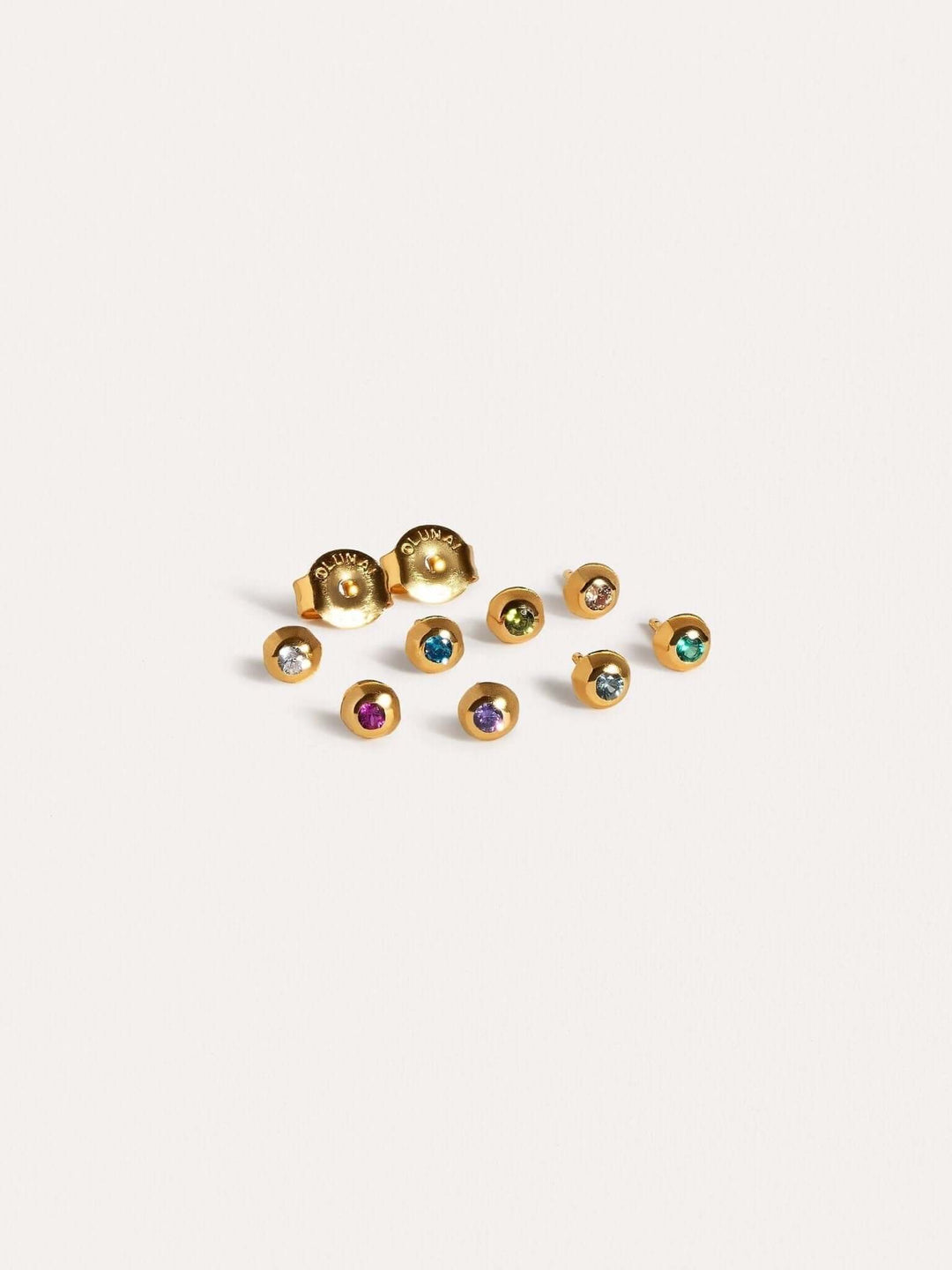 Set of gold stud earrings with colorful gemstones in various shades.