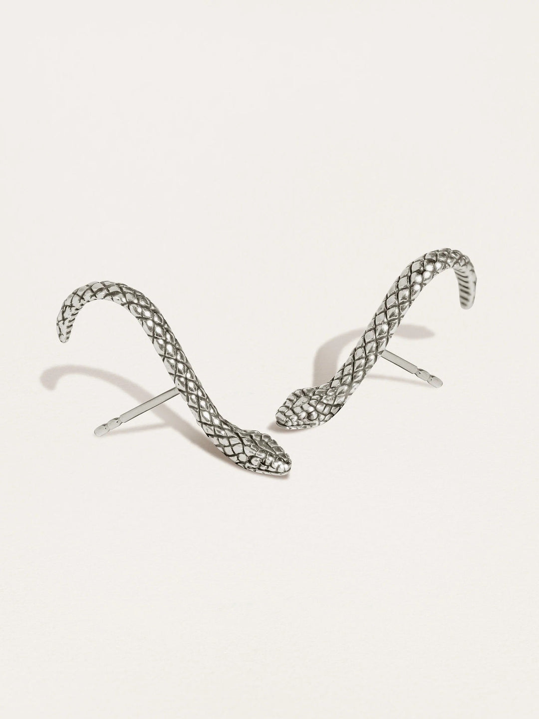 Snake Suspender Earrings in silver with intricate coiled design and dangling chains