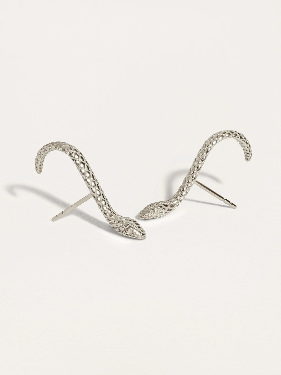 Unique Snake Suspender Earrings in gold featuring detailed snake head and sleek, dangling chains