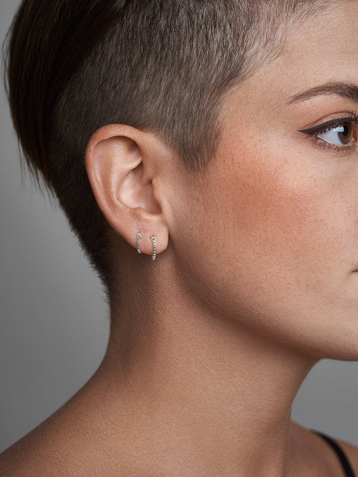 Three-quarter view of model wearing dainty threader earring