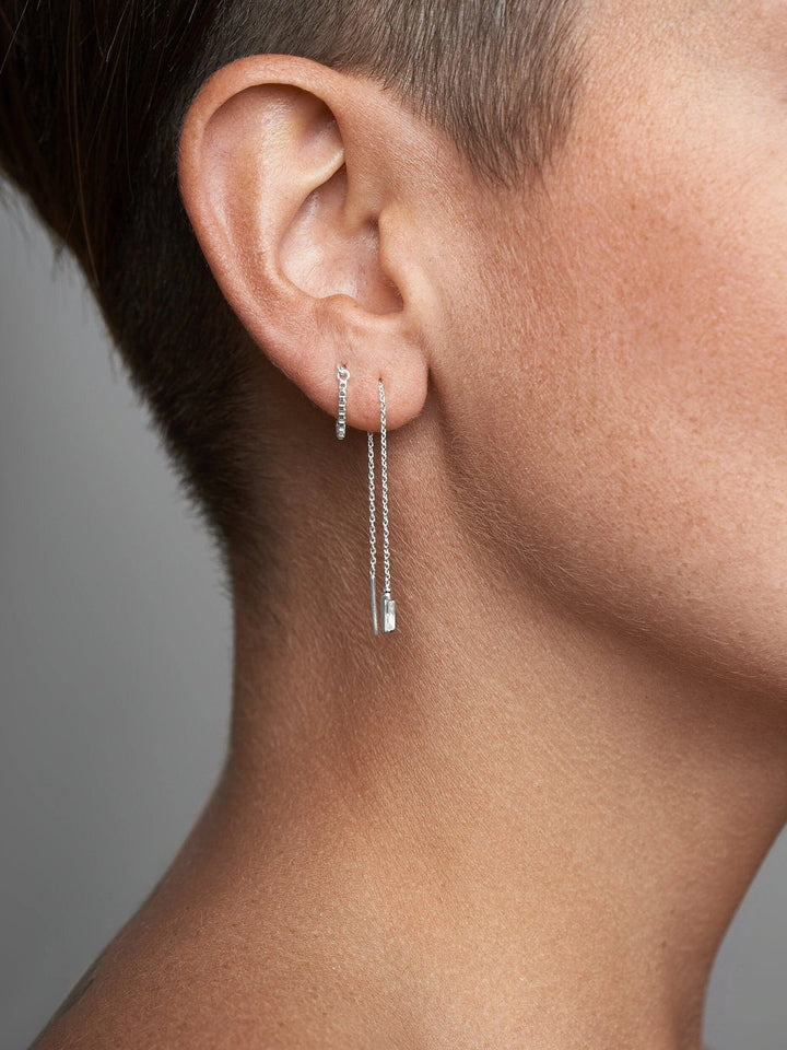 Minimalist gold threader earring with dangling chain, frontal angle