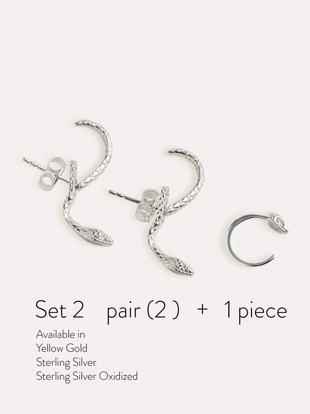Sterling silver snake earrings set with a matching huggie hoop, featuring intricate detailing and a bold yet elegant design.