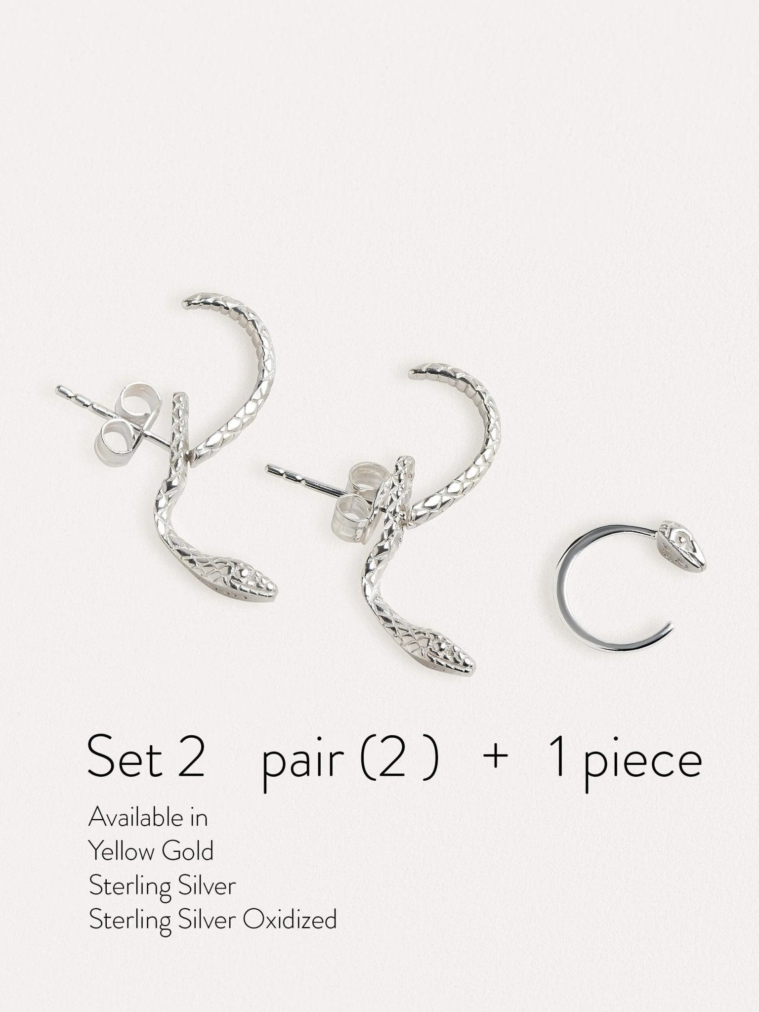 Sterling silver snake earrings set with a matching huggie hoop, featuring intricate detailing and a bold yet elegant design.