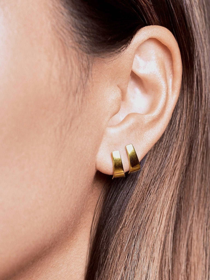 Terita gold stud earring worn — 24K gold plated finish with sculptural shape and warm glow.