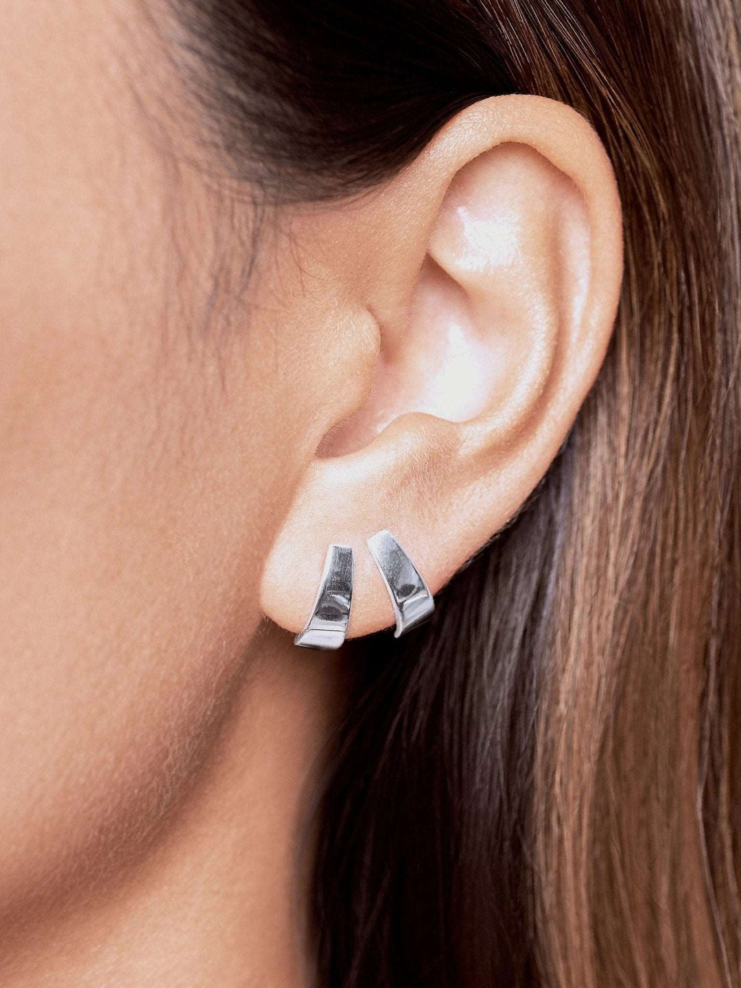 Sterling silver Terita stud earring worn — classic, lightweight design with refined shine.