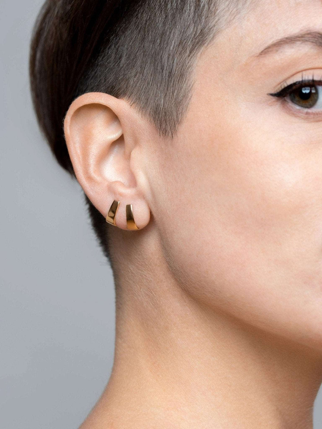 Terita stud earring in 24K gold plated finish — worn on ear with soft shine and minimalist elegance.