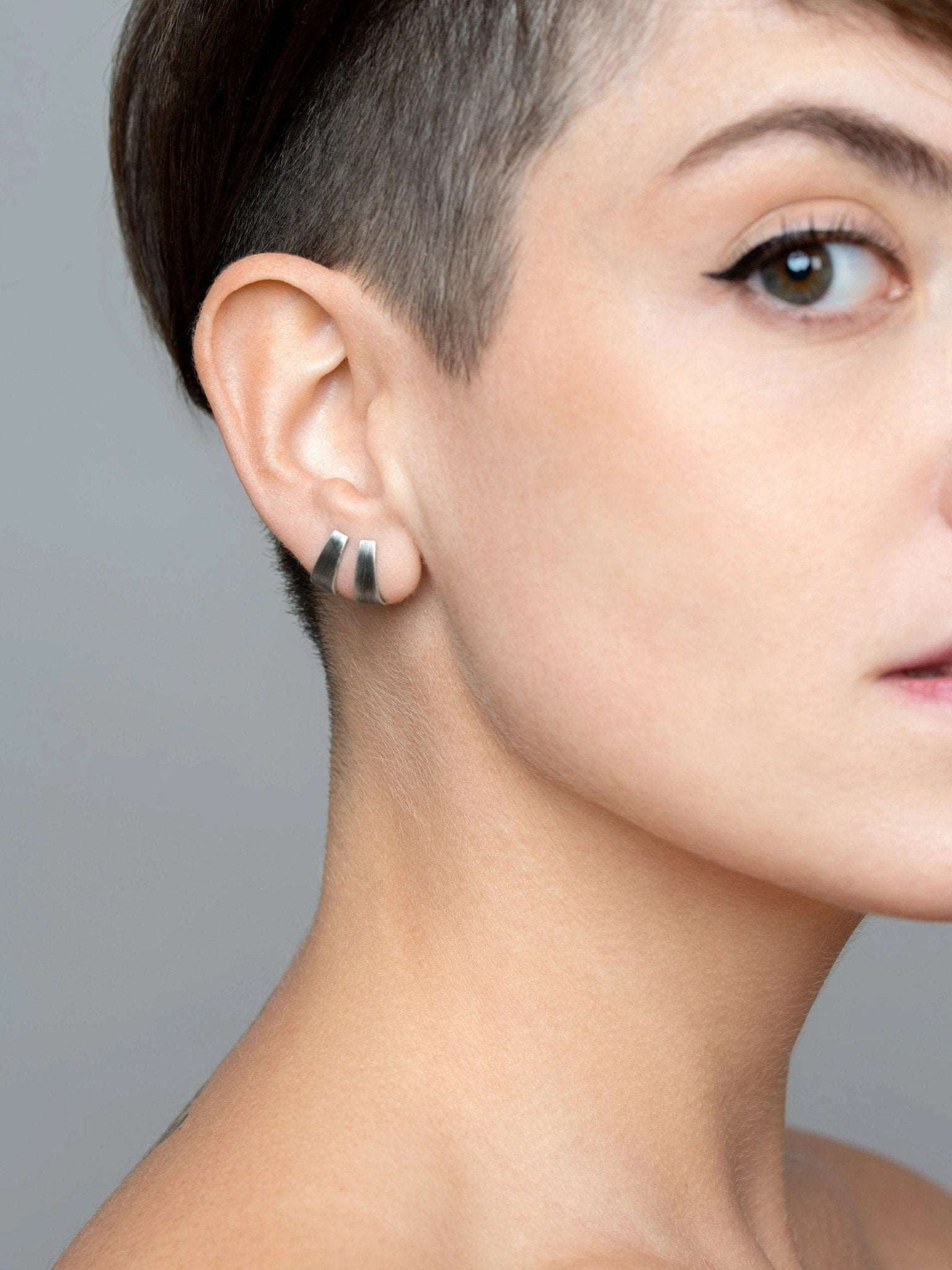 erita stud earring in oxidized silver worn — soft polished surface with sculptural, modern feel.