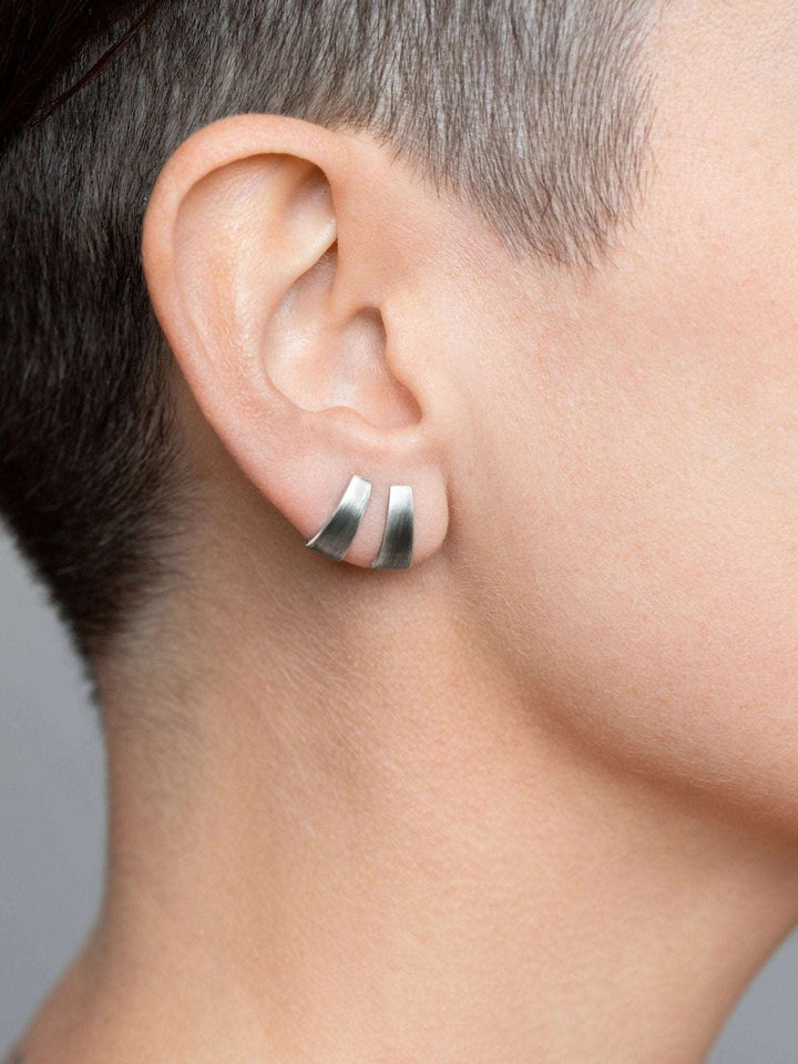 Terita stud earring in oxidized silver worn — bold, matte finish with minimalist styling.