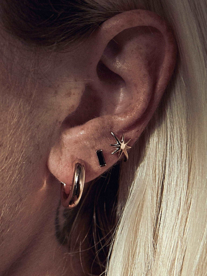 Birte open hoop earring in gold plated finish — radiant, lightweight, and bold on ear.