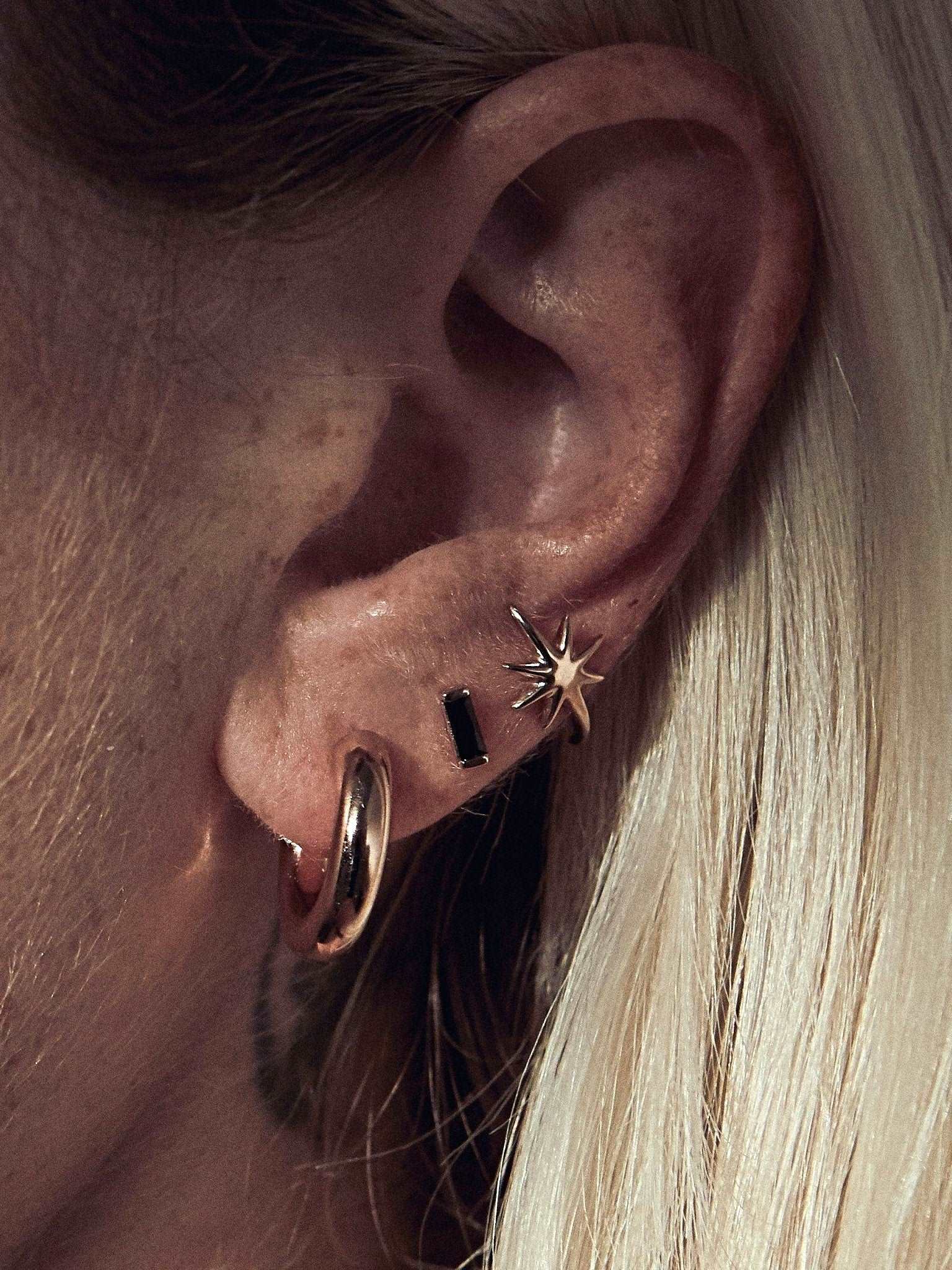 Birte open hoop earring in gold plated finish — radiant, lightweight, and bold on ear.