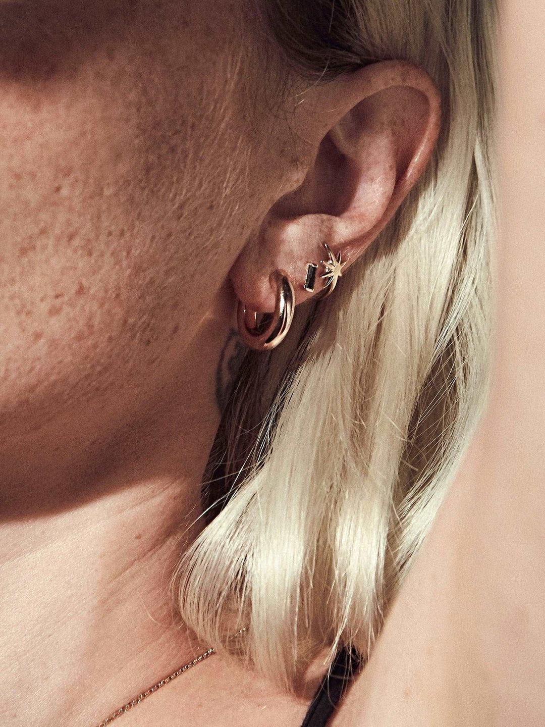 Birte hoop earrings layered or styled — versatile, handcrafted elegance in gold and silver.
