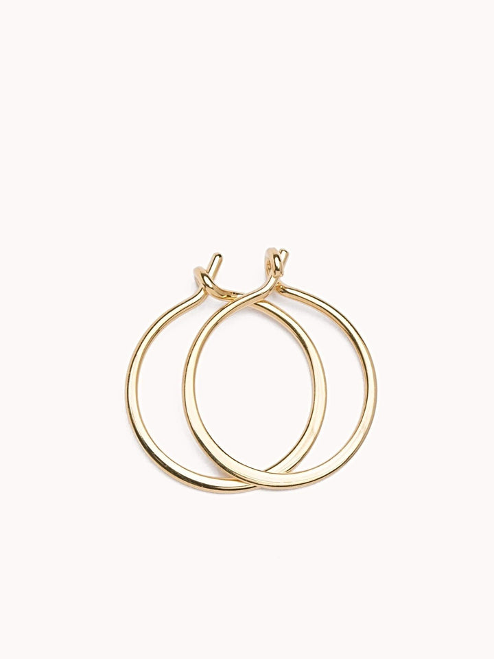 Double Rose  gold  hoop earrings, minimalist and elegant, on a soft pink background