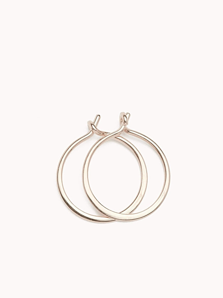 18K rose gold filled hoop earrings with a delicate open design on a soft pink background