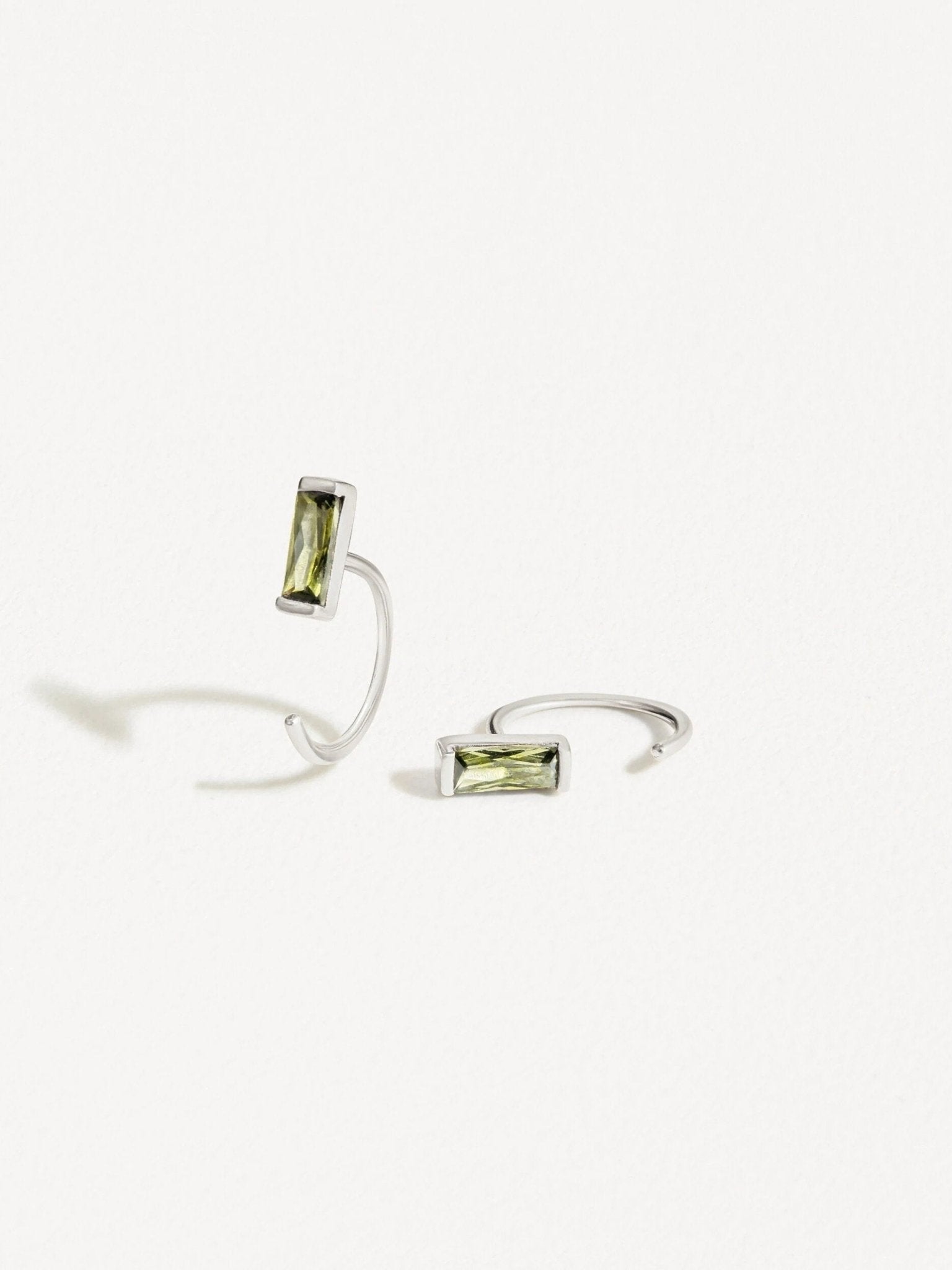Close-up of peridot open hoop earrings in rose gold, highlighting the sleek and lightweight design.