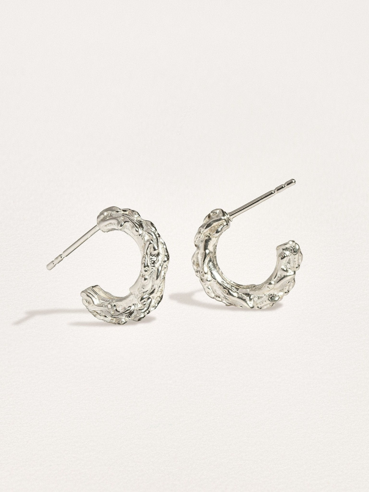Groessa Raw Texture Open Hoop Earrings in silver showcasing versatile design.
