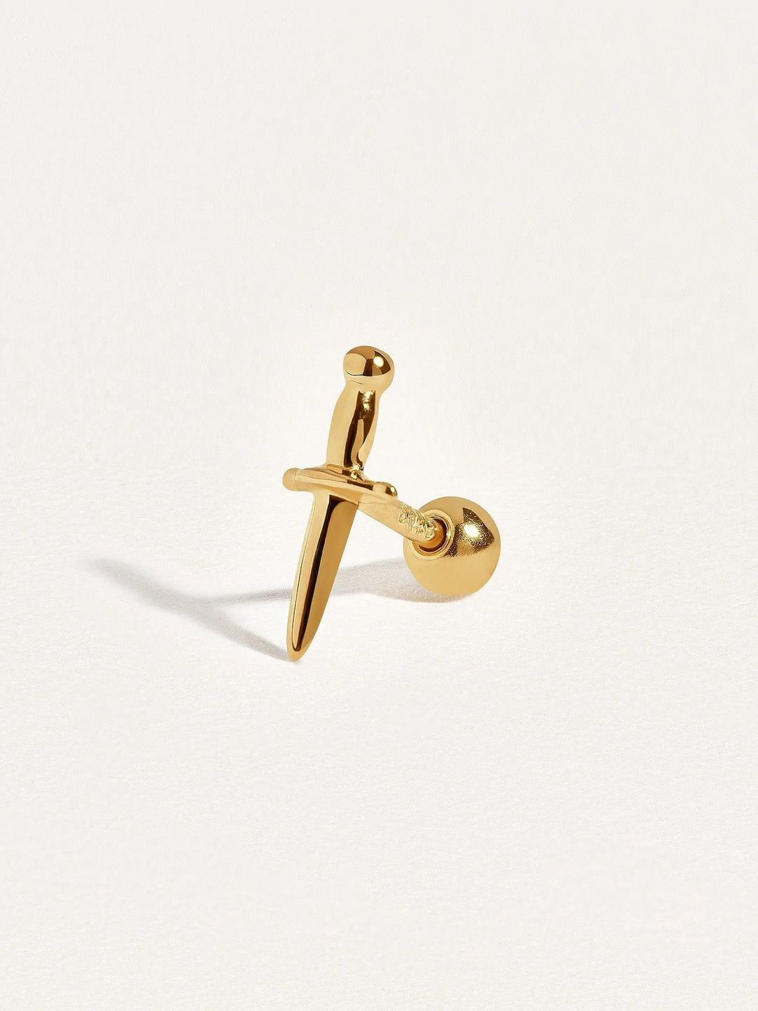 Single gold dagger cartilage stud with ball back, angled view showing secure screw design and delicate shine.