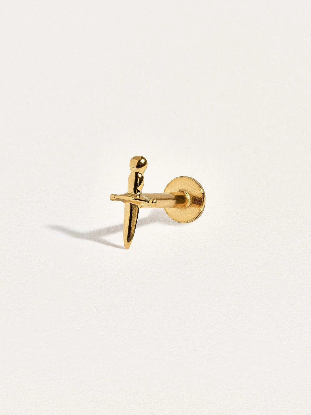 Single flat back dagger earring in 24k gold vermeil, shown close-up to highlight fine details and smooth finish.