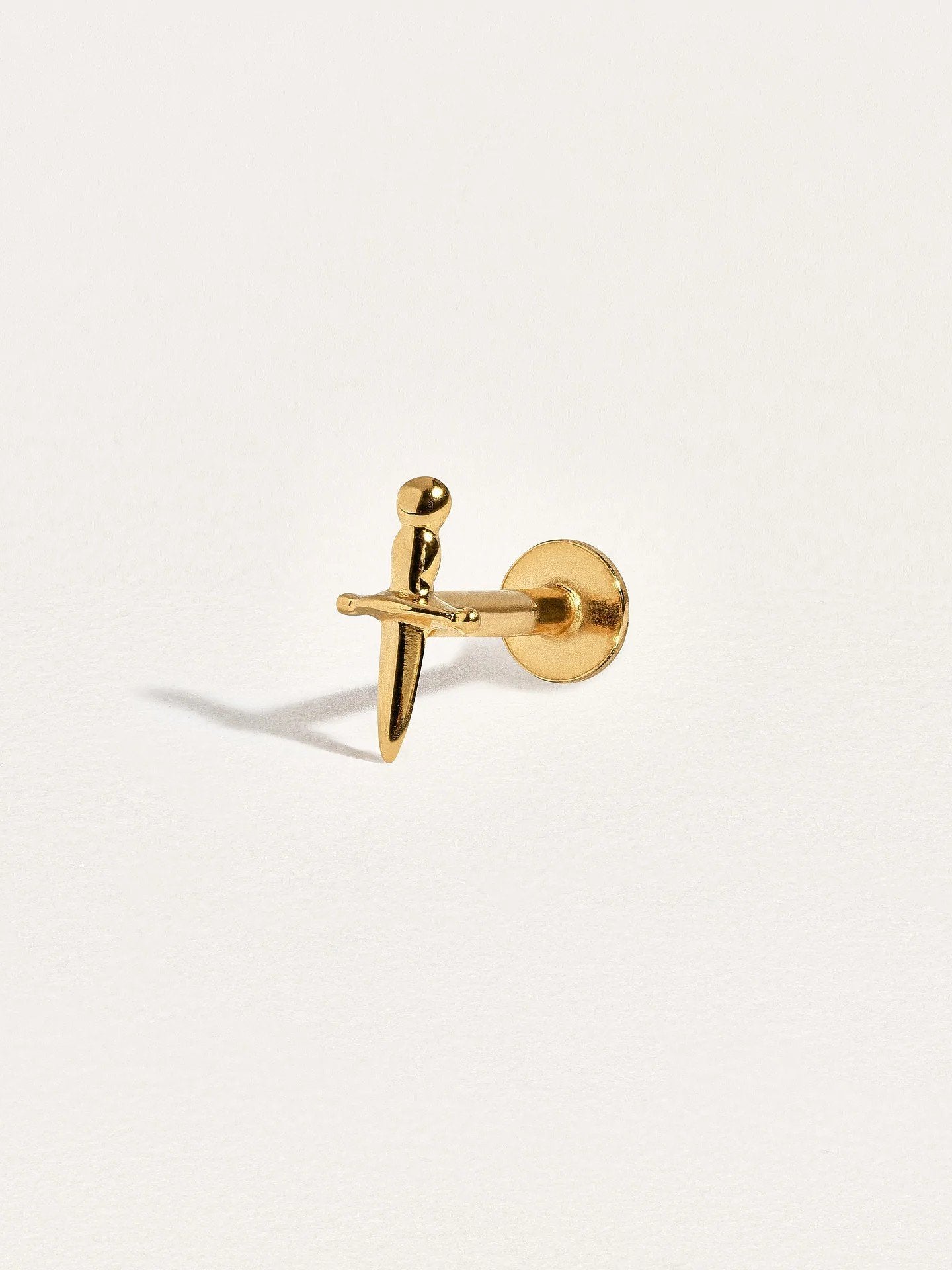 Single flat back dagger earring in 24k gold vermeil, shown close-up to highlight fine details and smooth finish.