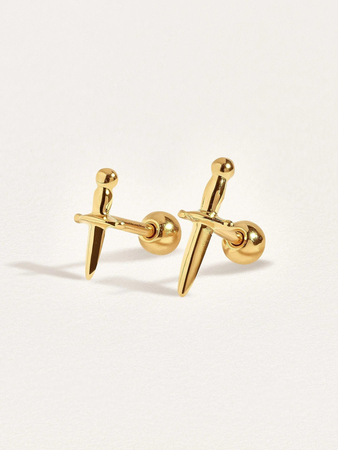 Two dagger earrings in 24k gold vermeil, side by side to show different dagger sizes and fine details of the design.