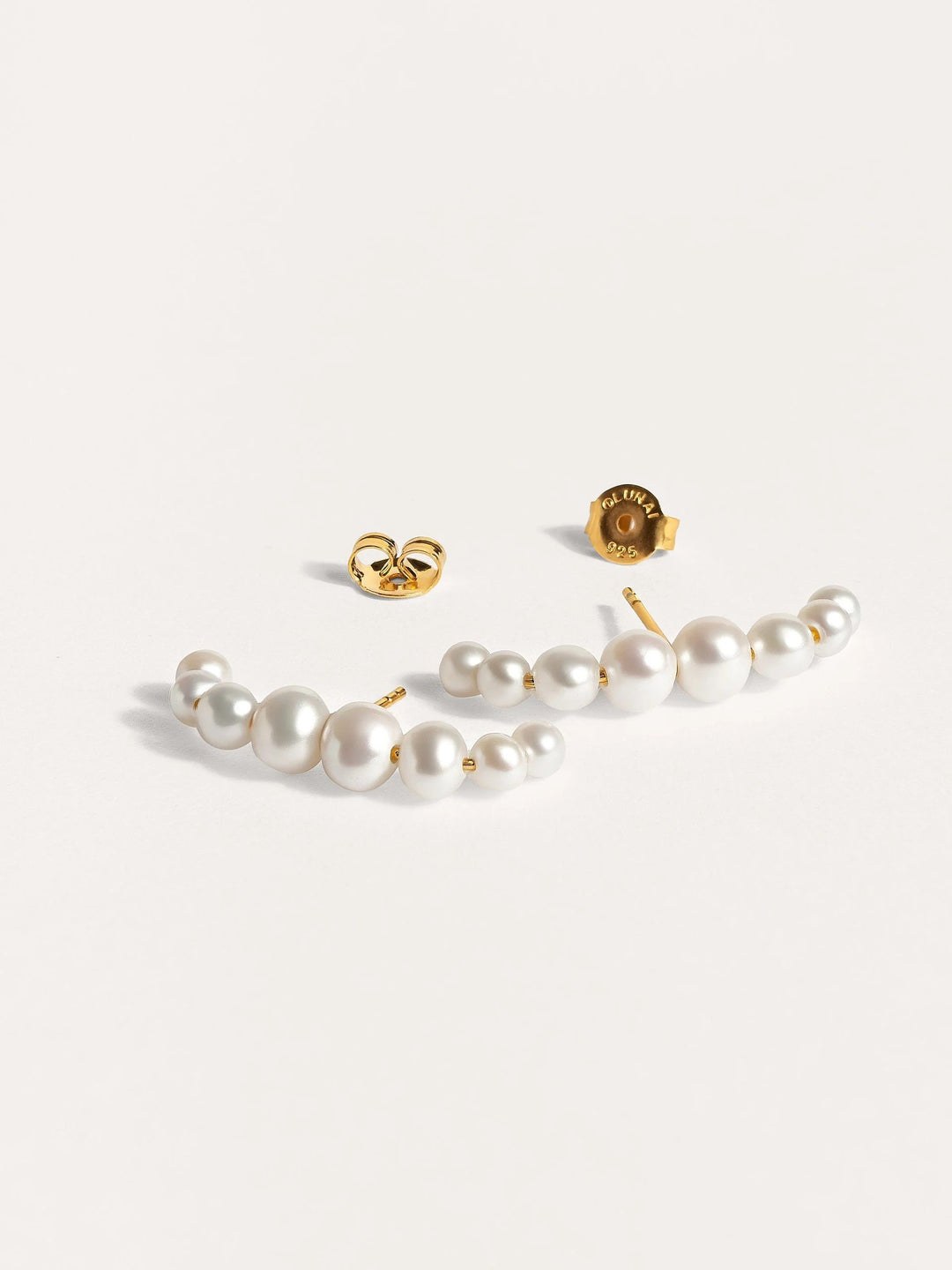 Detailed shot of the Solene pearl ear cuff, showcasing the handcrafted texture and 24k gold plating.