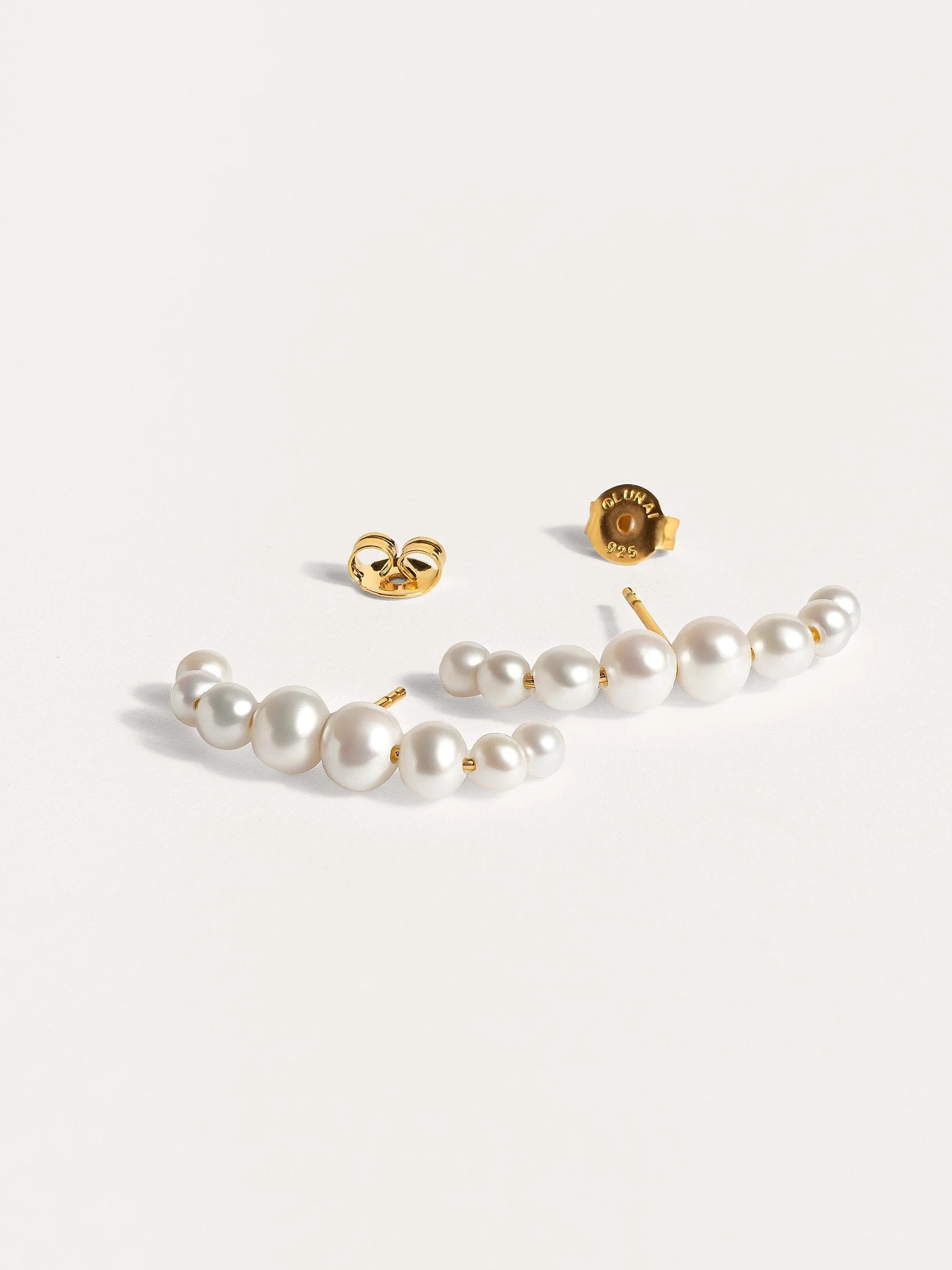Detailed shot of the Solene pearl ear cuff, showcasing the handcrafted texture and 24k gold plating.