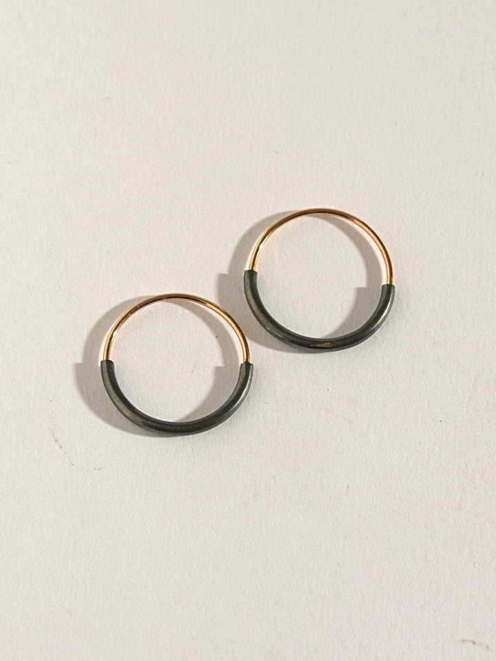 Pair of Kim small hoop earrings in gold filled and oxidized silver — clean contrast design.
