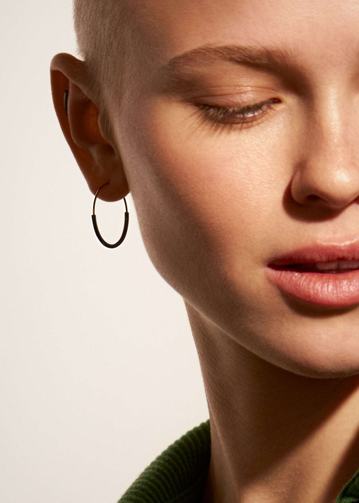 Kim small hoop earring in 14K gold filled — worn close-up, elegant and minimal look.