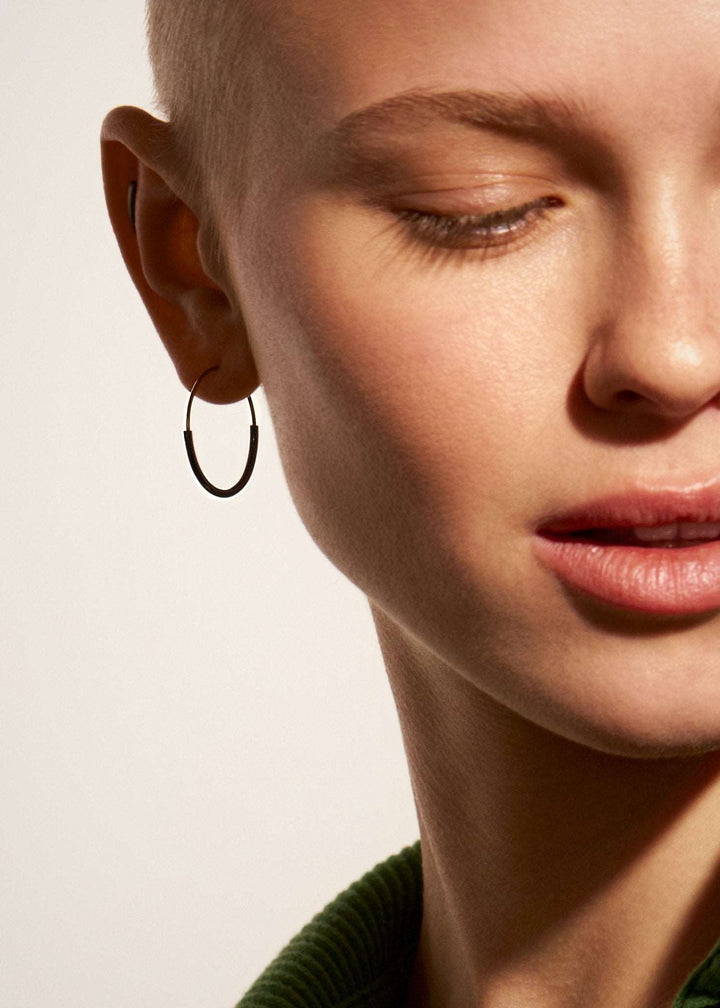 Kim small hoop earring in 14K gold filled — worn close-up, elegant and minimal look.