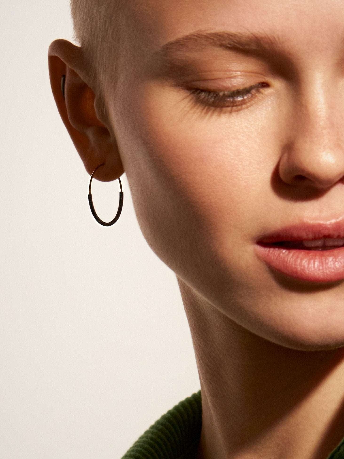 Kim small hoop earring in 14K gold filled — worn close-up, elegant and minimal look.
