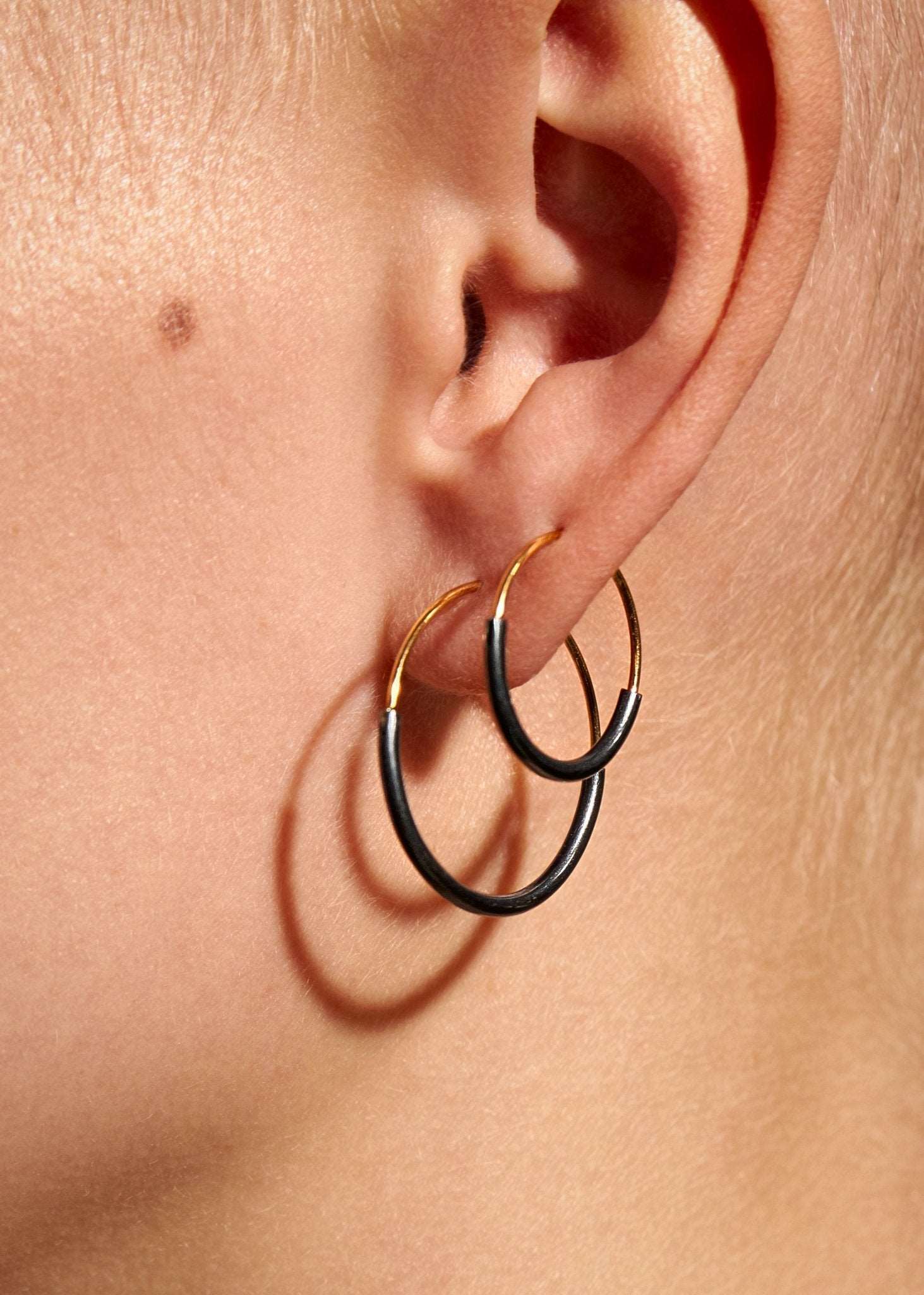 Kim hoop earrings layered in gold filled and oxidized silver — playful and sculptural look.