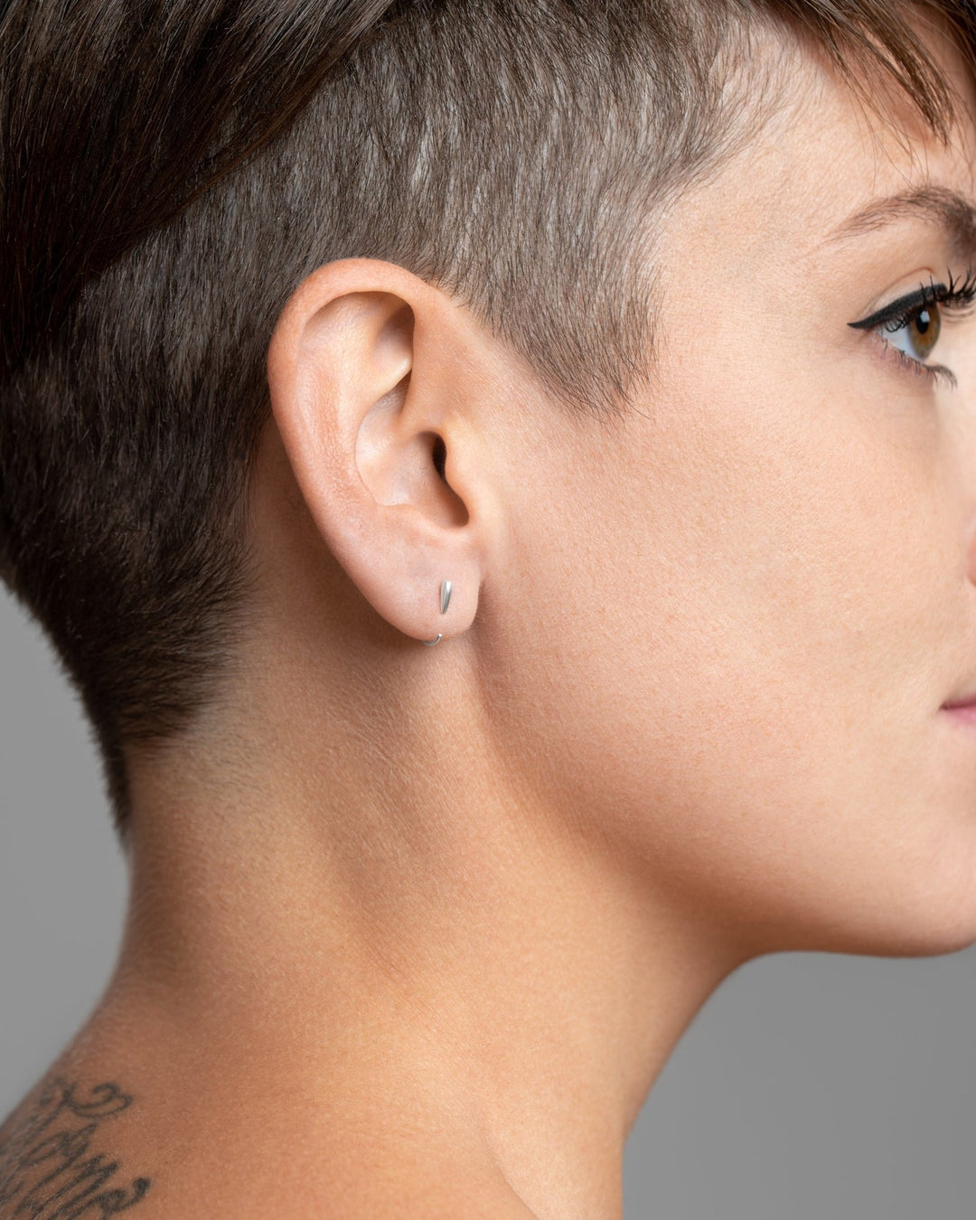 Sterling silver Luppa earring worn — tusk-inspired form with refined minimalism.