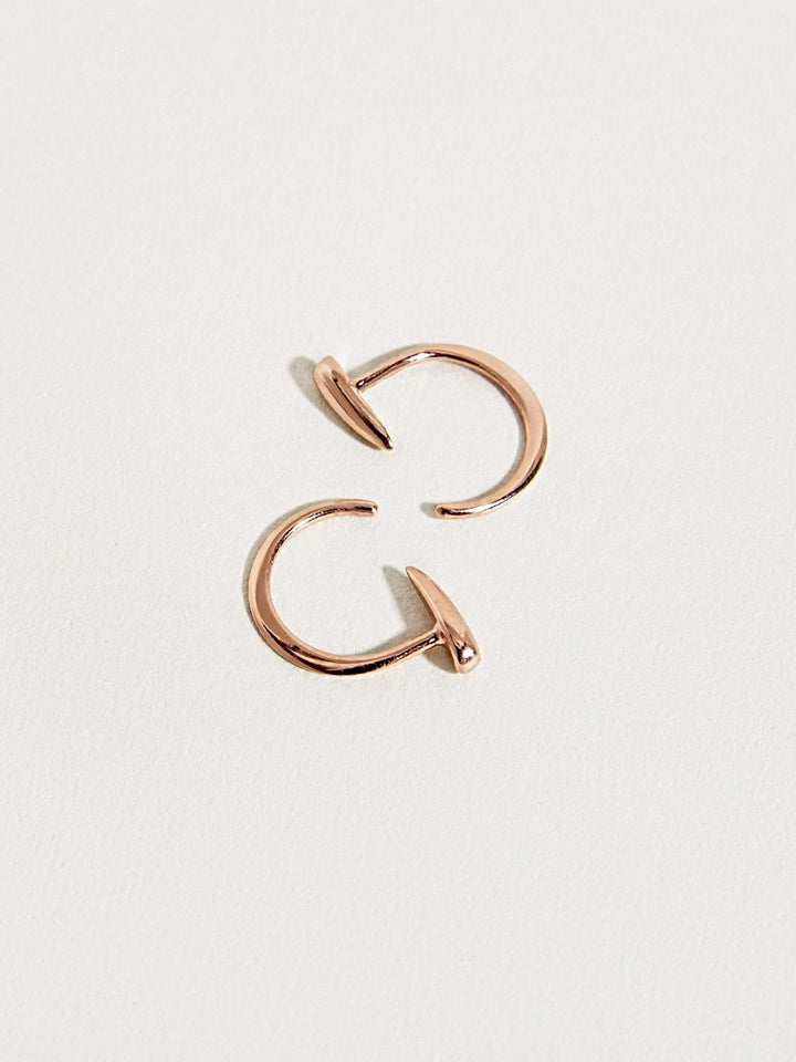 Luppa gold hoop earrings with curved open design — tusk-inspired silhouette.