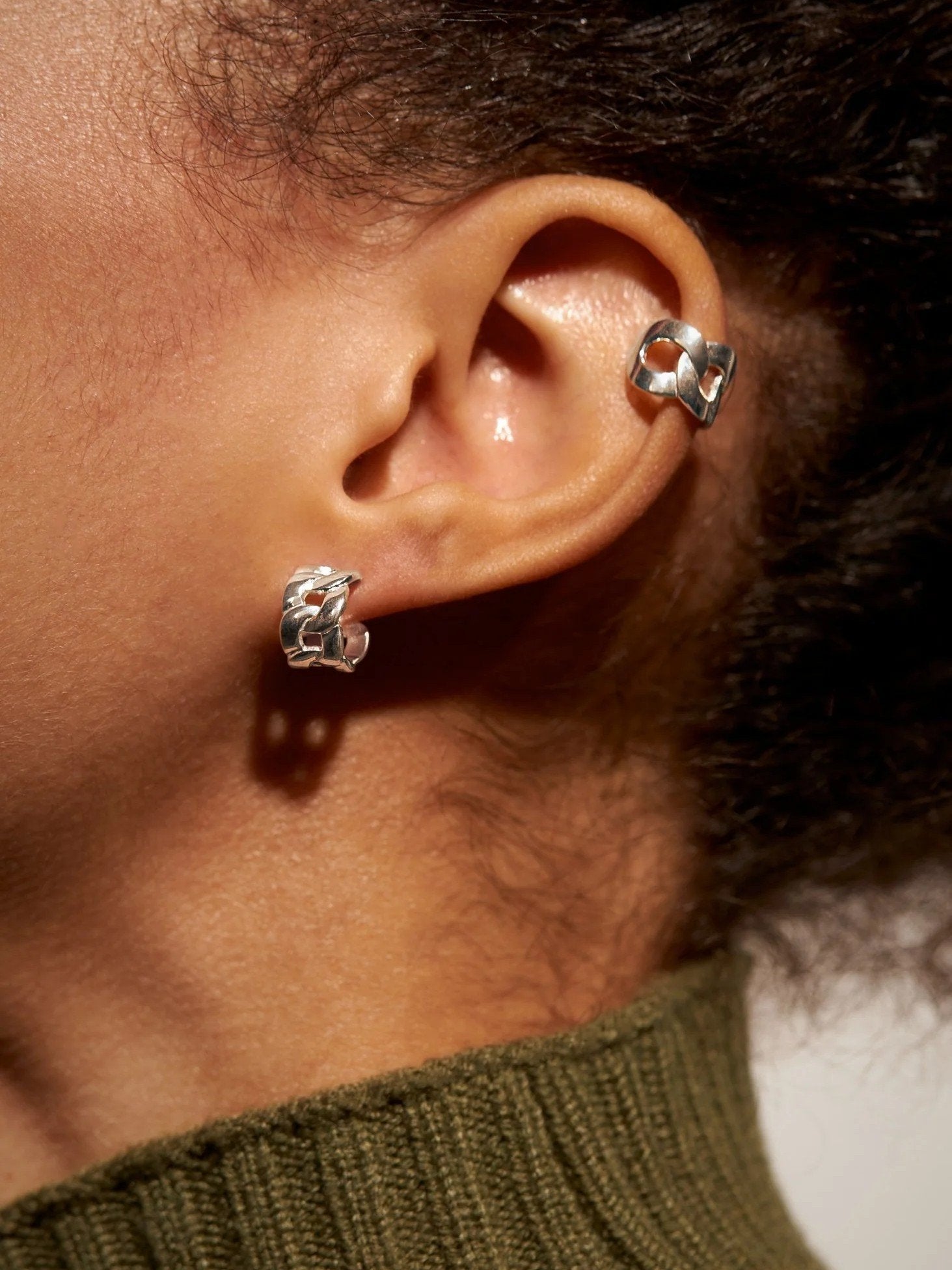 Meel Gold Hoop Earrings styled on dark skin tone with textured hair — modern, bold, and luminous against the skin.