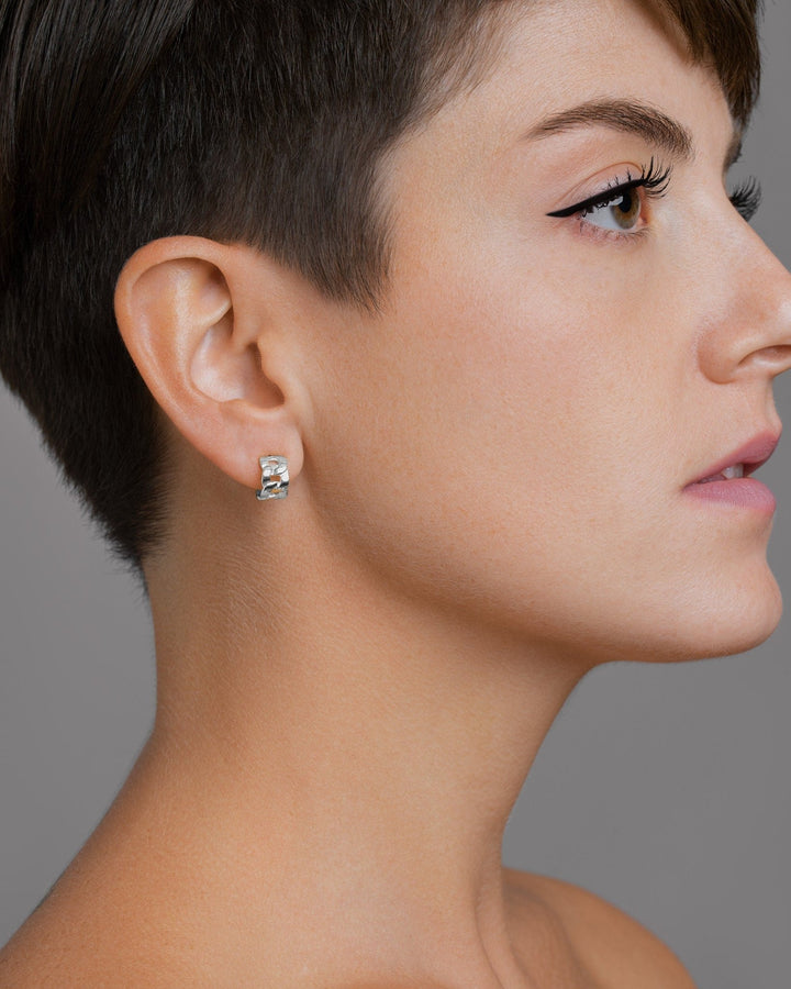 Right-side view of the Meel Gold Hoop Earrings styled on a model with pixie cut, showcasing their sculptural chain-inspired form.