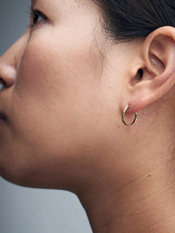 Nanna huggie earring in matte rose gold plated finish — hugging the lobe with soft texture.