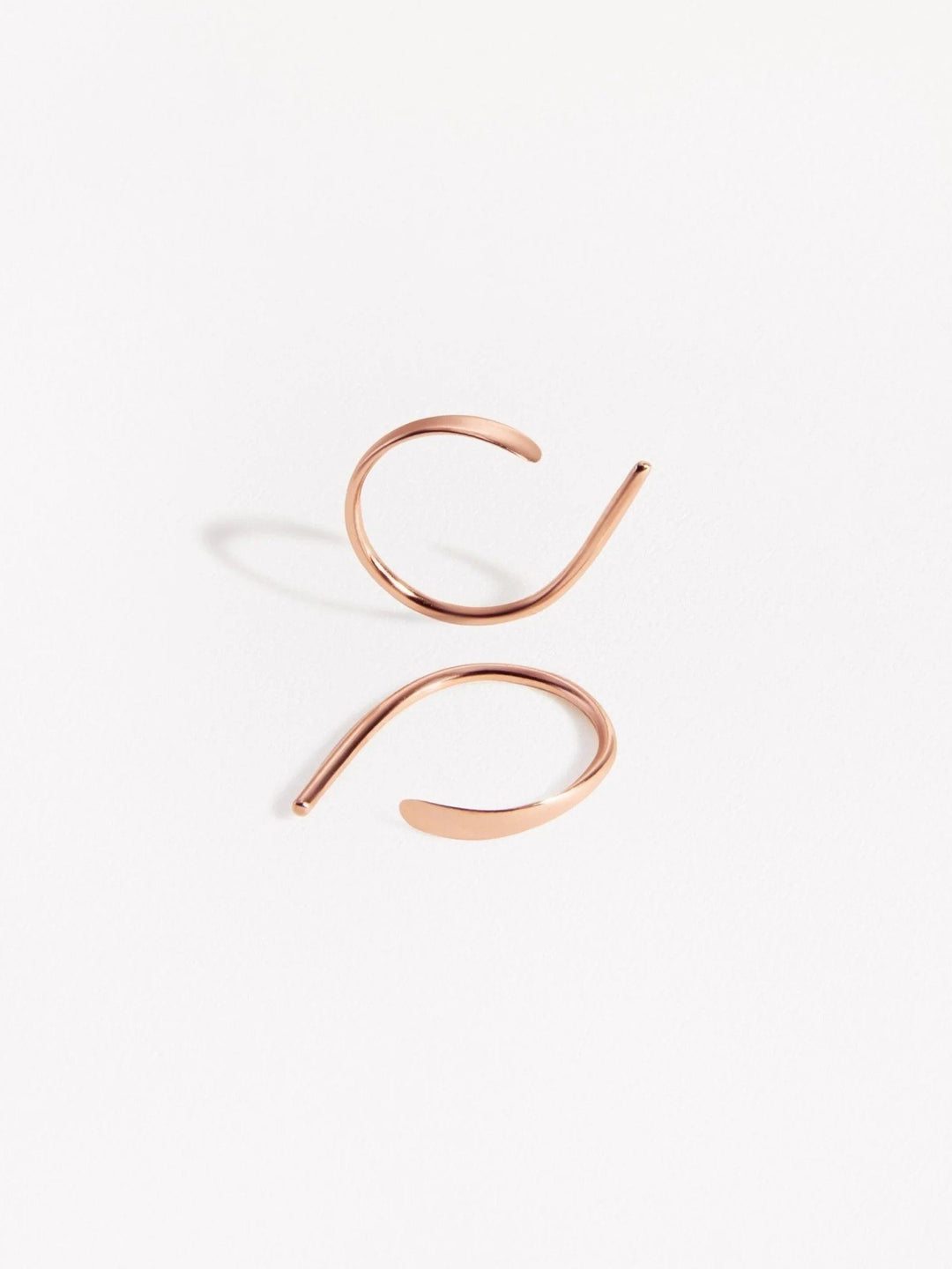 Rose gold version of Noe hammered hoop earrings — delicate and luminous design handmade in sterling silver.