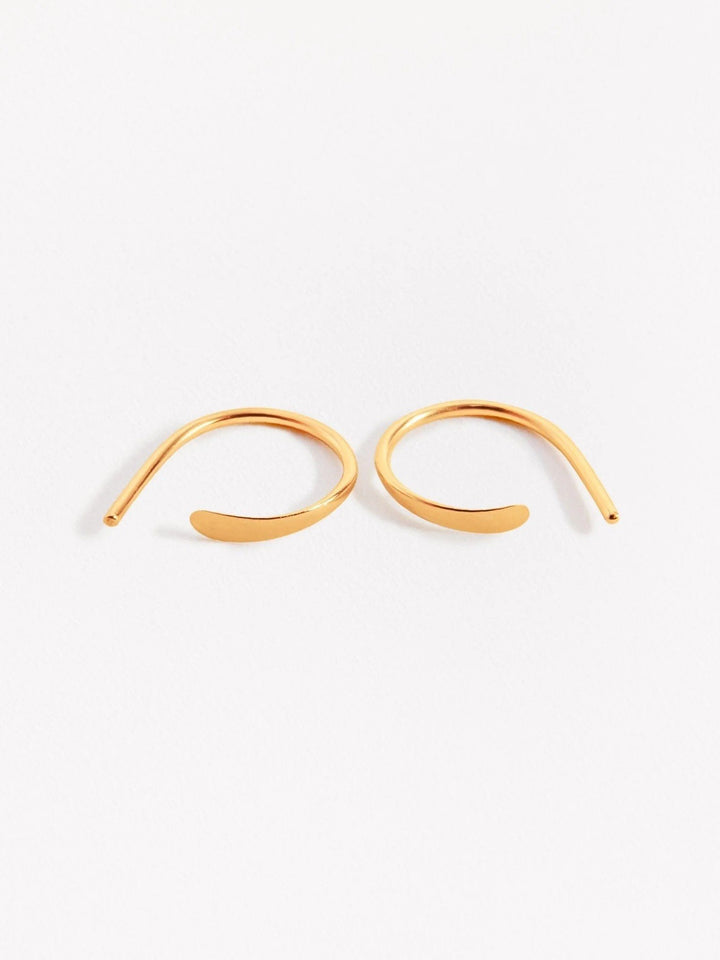 Noe hoop earrings in gold — gently curved and hammered front, shown side by side on white backdrop.