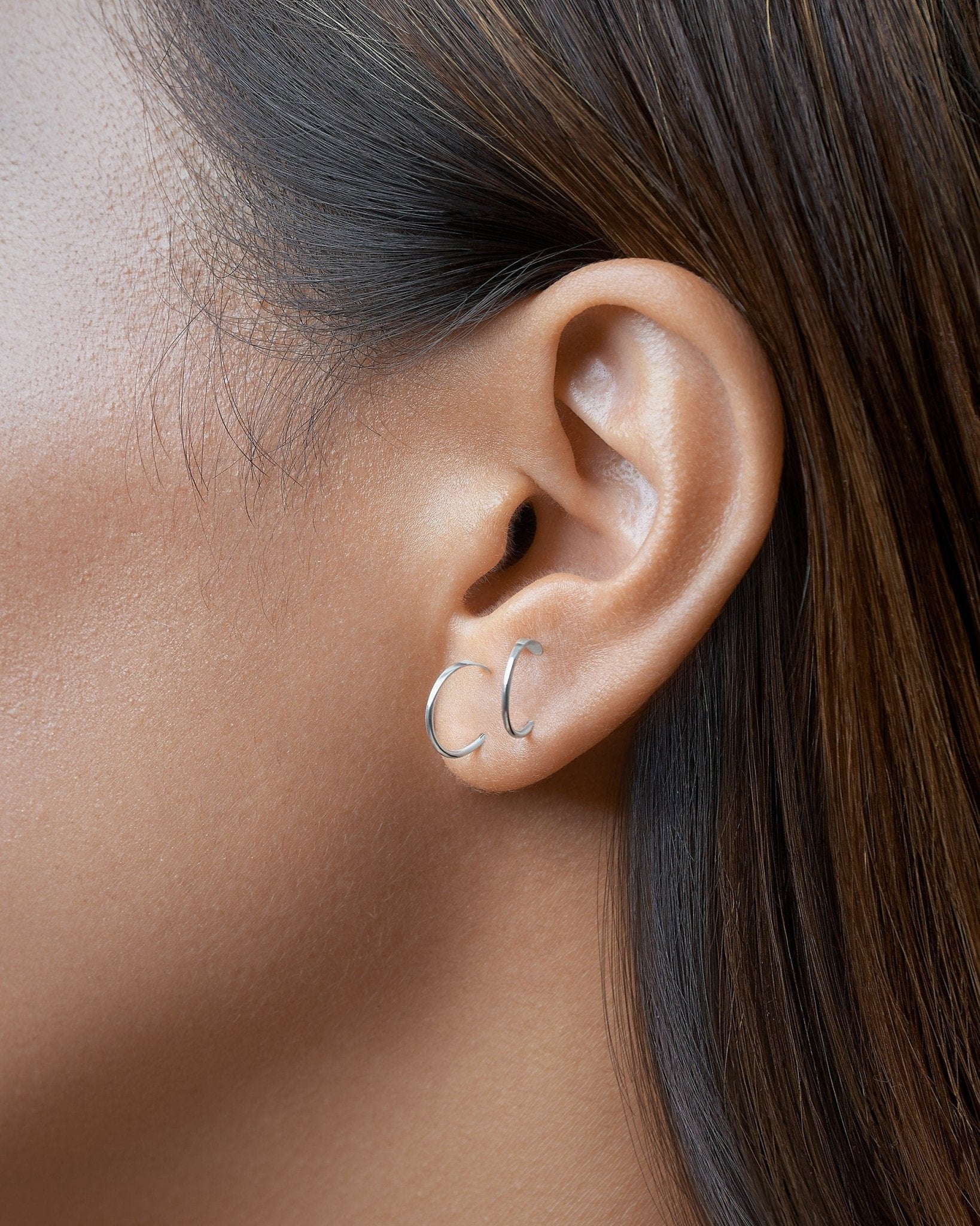 Gold Noe hammered hoop earring worn — close-up showing soft curve and elegant shine in real wear.