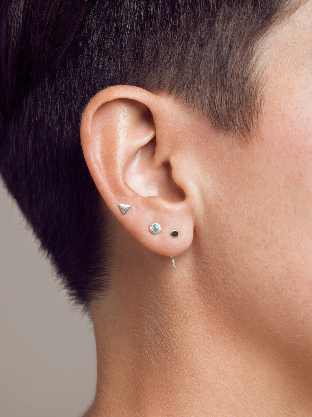 Silver open hoop earrings worn on a model, lightweight and elegant.