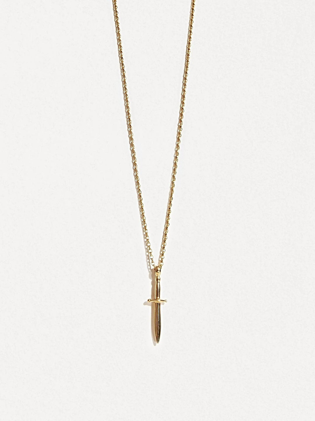 Gold dagger necklace on white background, front-facing product shot.