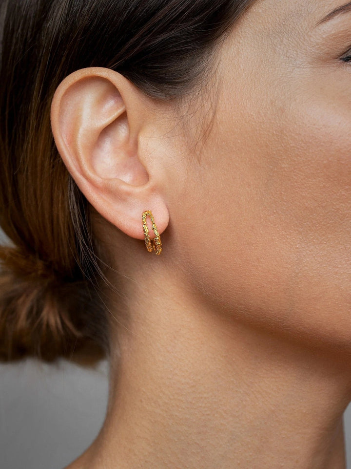 Model wearing Priana Gold Double Hoop Stud Earrings, showcasing elegant style.