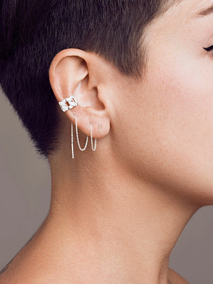 Renatte gold ear cuff worn — statement look with modern short haircut.