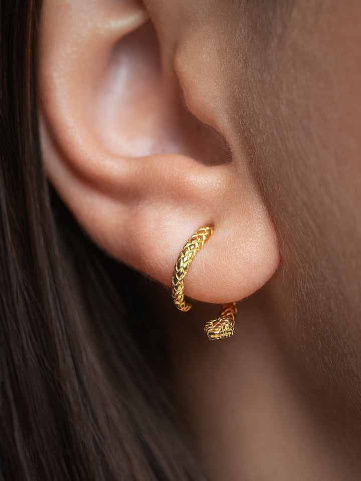 24K gold plated snake ear jacket worn by a model with warm skin tone, close-up view.